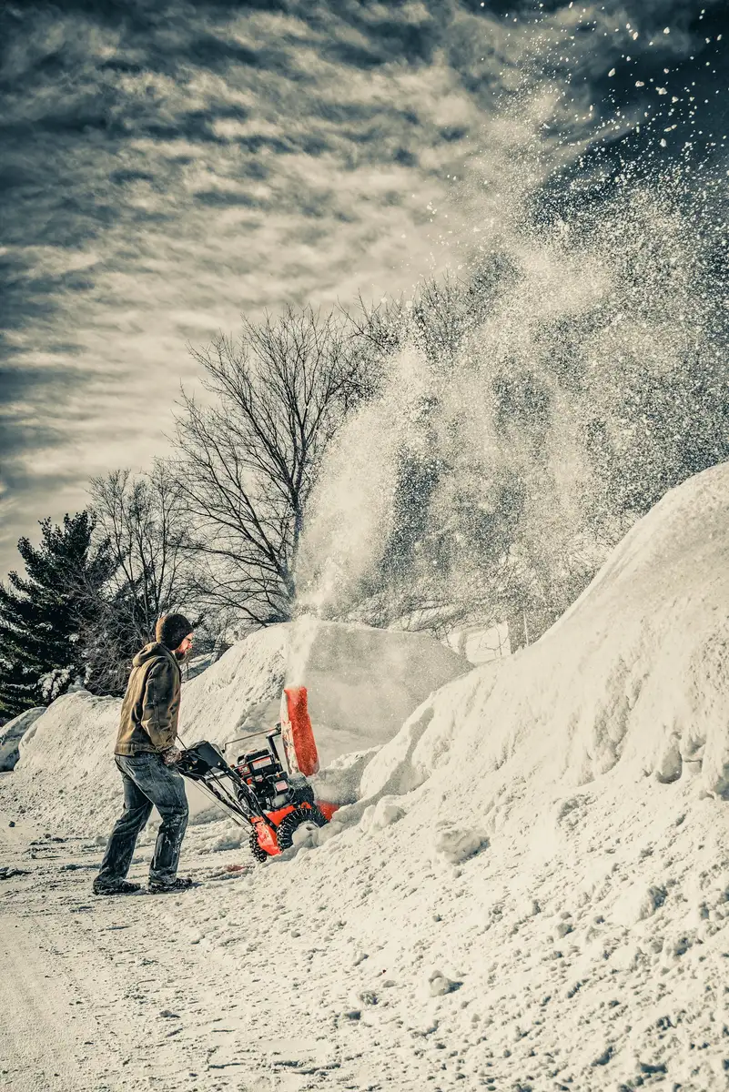 Snow blower throwing deep snow off a driveway